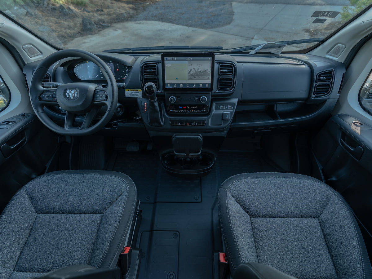 Interior view of an RV rental van's cockpit, featuring the modern dashboard, infotainment screen, and front seats. — photo 10