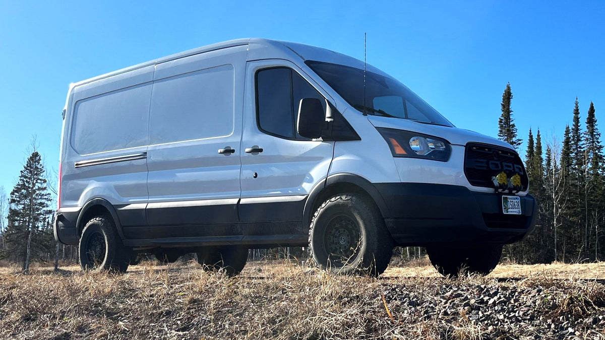 Off-road-ready white Ford Transit van