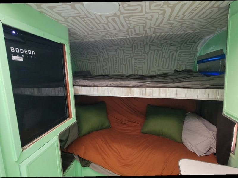  and mountain views.|This bright green rv rental interior features a retro kitchen — photo 4