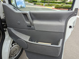 Inside an rv rental's door: gray panel, handle, speaker, and storage with notes.