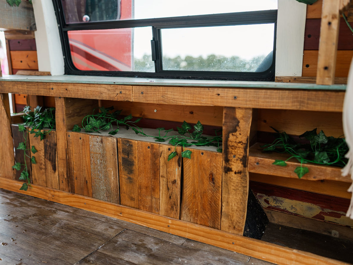 and a "Look At How Far You've Come!" sign.|Woman enjoys remote work on her laptop in a cozy RV rental. Features wooden interior — photo 15