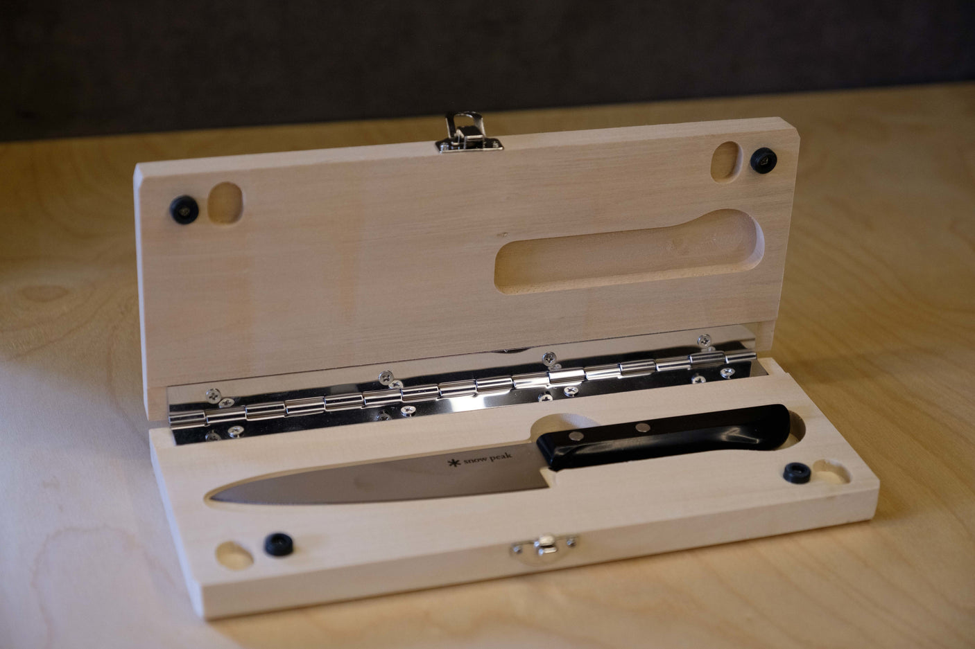Portable Snow Peak kitchen knife in a custom wooden box, ready for your RV rental journey or camping. Essential gear.