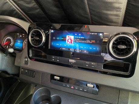 RV rental dashboard with high-tech infotainment playing SiriusXM, showing 43k miles and climate settings.