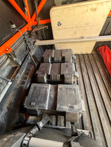 Off-road adventure vehicle bed with three portable battery boxes secured, overhead storage, and wiring. Great for RV rental trips.