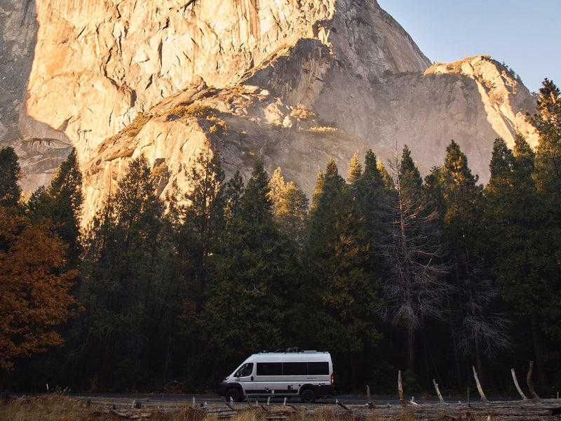  snow-capped mountains.|RV rental van on a winding desert dirt road with mountains under a blue sky — photo 4