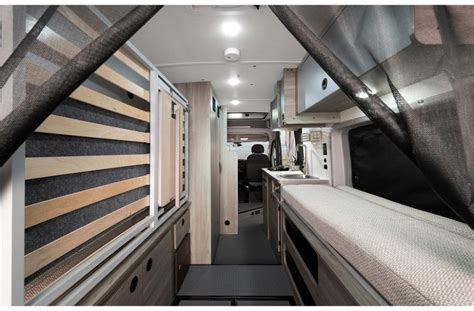  treed area. Book your rv rental getaway.|RV rental floor plan: Top-down view of a camper van's interior. Features a Murphy bed — photo 2