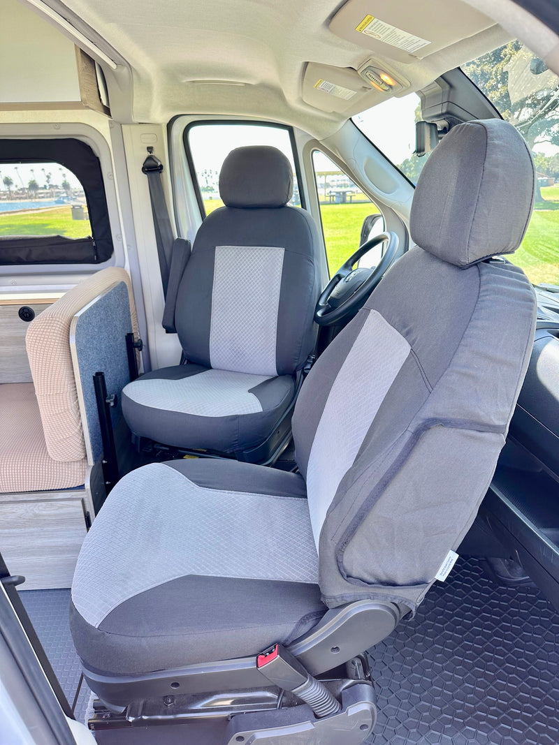 RV rental interior with comfortable, custom-covered front seats that swivel for flexible living space. — photo 14
