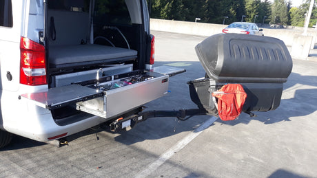 Experience outdoor living with this RV rental camper van featuring a convenient pull-out kitchen and rear storage.