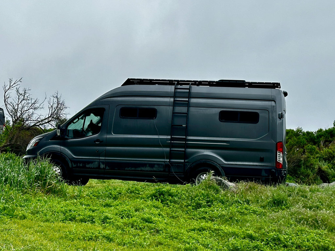 Dark grey RV rental camper van with a roof rack and ladder — photo 1