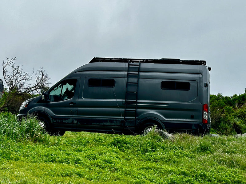 Dark grey RV rental camper van with a roof rack and ladder — photo 1