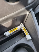 Two interconnected bubble levels rest on an RV rental's console, useful for ensuring the vehicle is level for a comfortable stay.