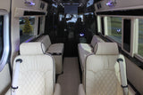 Explore our luxurious RV rental interior. Features include plush cream quilted leather seats, large side windows, and spacious comfort for travel.