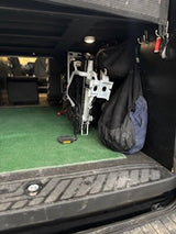 RV rental ready: Organized storage features a folded white bike, two bags, and a green mat for your travel adventure.