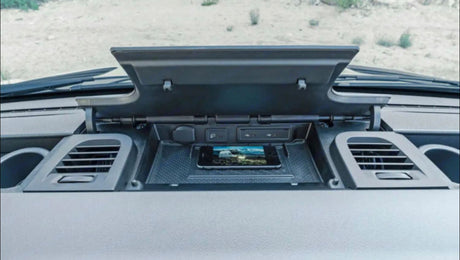 RV rental interior: A dashboard compartment opens to reveal a phone charging pad, USB ports, and air vents.
