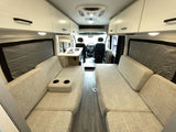 Modern camper van interior, perfect for your RV rental road trip. Features comfy seating, dinette, and ample storage.