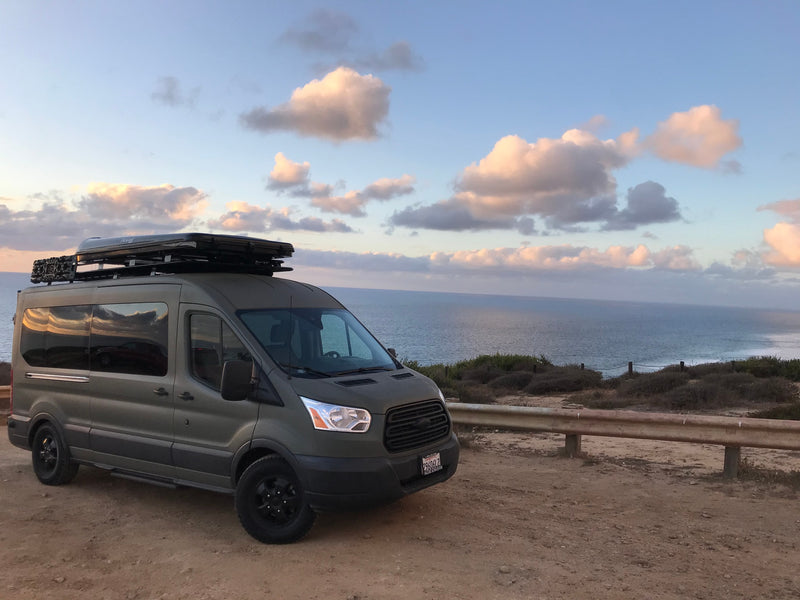 Dark green RV rental van with rooftop tent, parked overlooking the ocean at dusk. Perfect for travel adventures. — photo 16