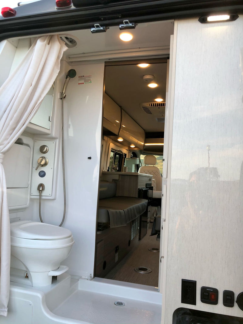  and an outdoor view. Basecamp mug on counter.|Step inside this cozy RV rental's inviting living space — photo 10