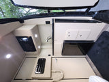 RV rental interior features a cream-toned kitchenette with microwave, sink, and mini-fridge, illuminated by recessed lighting.