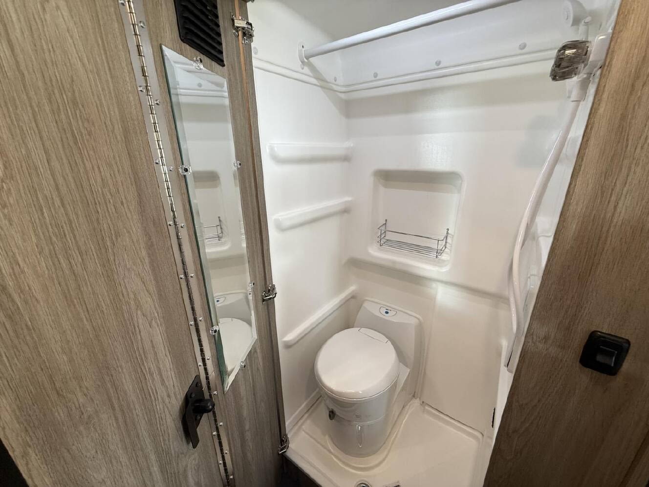 Enjoy an unforgettable **rv rental** adventure! White RAM Solis camper van parked in a golden field with mountains at a vivid sunset.|Family enjoying their RV rental campervan at a forest campsite. Kids play near the parked vehicle with its pop-top roof open.|This RV rental's interior features a compact dining area — photo 6