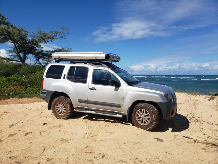  ready for adventure camping. Explore with this RV rental alternative.|Off-road RV rental adventure! Silver SUV with rooftop tent on a sandy dune overlooking a turquoise beach.|Clean car interior — photo 4