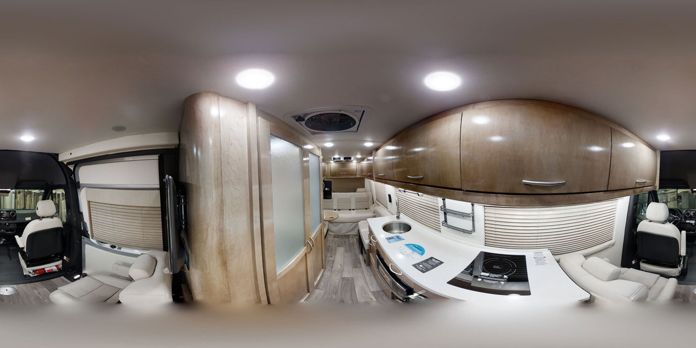 Inside this modern RV rental: sleek kitchen, cozy living space, and organized cabin for comfortable journeys.