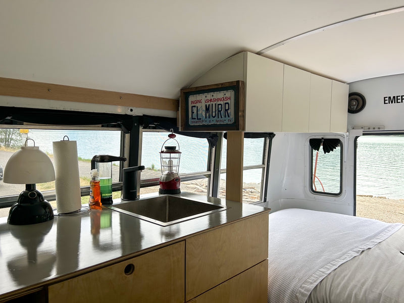 Experience the freedom of an RV rental: a stylish bus conversion with a full kitchen, bed, and stunning lake views. — photo 6