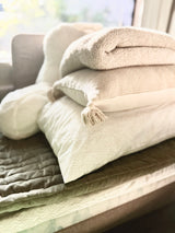 Cozy RV rental comfort awaits! Stack of clean, soft pillows, blankets & quilted comforter for your trip.