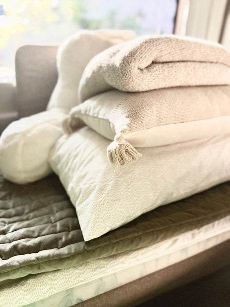 Cozy RV rental comfort awaits! Stack of clean, soft pillows, blankets & quilted comforter for your trip.