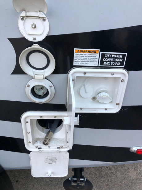 RV rental external connections: water hookup (max 50 PSI), electric shore power, cable, and quick-connect hose.