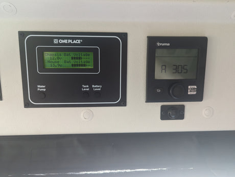 RV rental control panel: OnePlace displays chassis/house battery (12.8v/13.9v), water, and tank levels. Truma iNet ready.