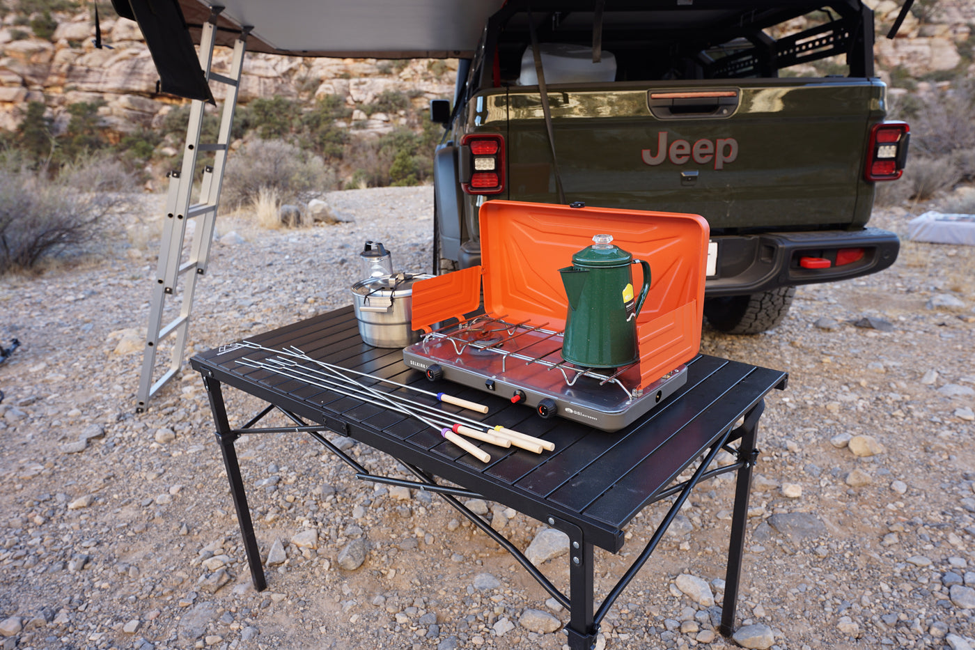 Enjoy an rv rental adventure! Portable stove, coffee pot, and roasting sticks ready on a table for delicious outdoor camping meals. — photo 7