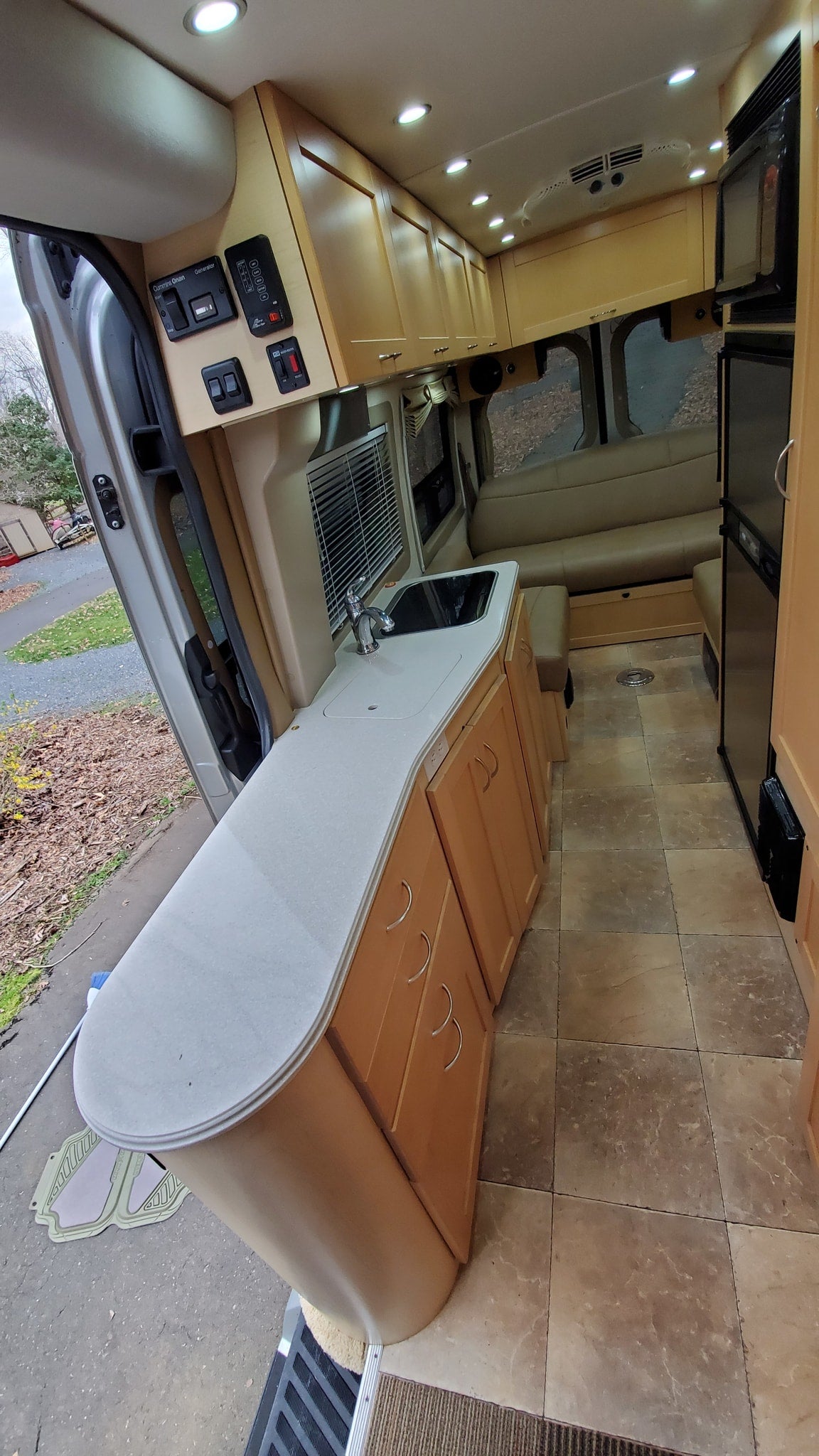  parked on a path scattered with pinecones.|Explore this spacious RV rental interior — photo 7