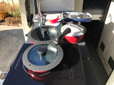 RV rental kitchen setup: portable induction cooktop, pots, collapsible bowls, and utensils for compact travel cooking.