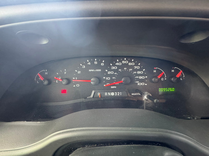An RV rental's dashboard with speedometer at 0 mph, fuel tank nearly full, odometer showing 95,260 miles, and the BRAKE warning light on. — photo 3