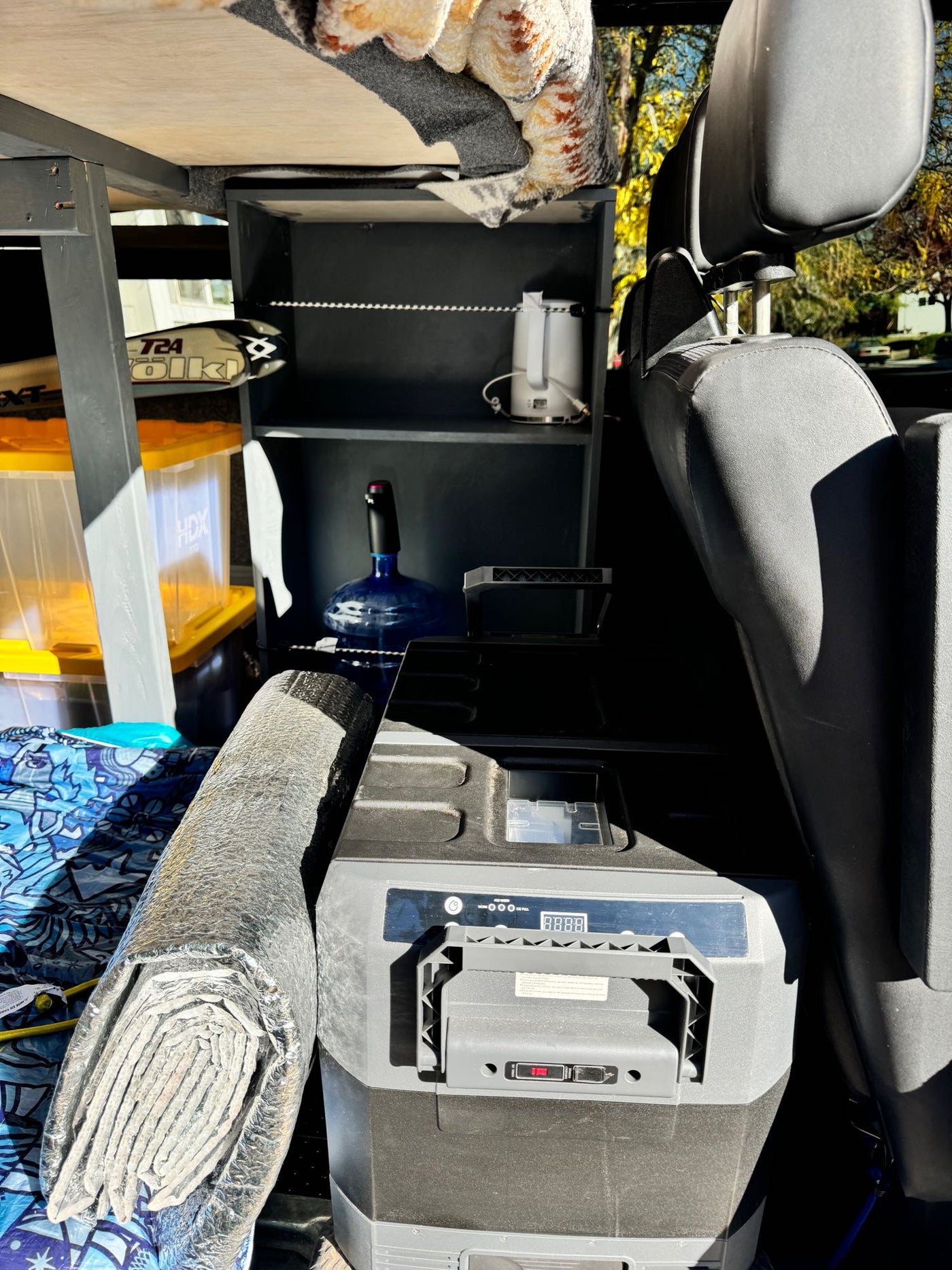  beside a vehicle seat. Practical for trips.|Inside an RV rental Sprinter van: driver's area with tablet mount — photo 13