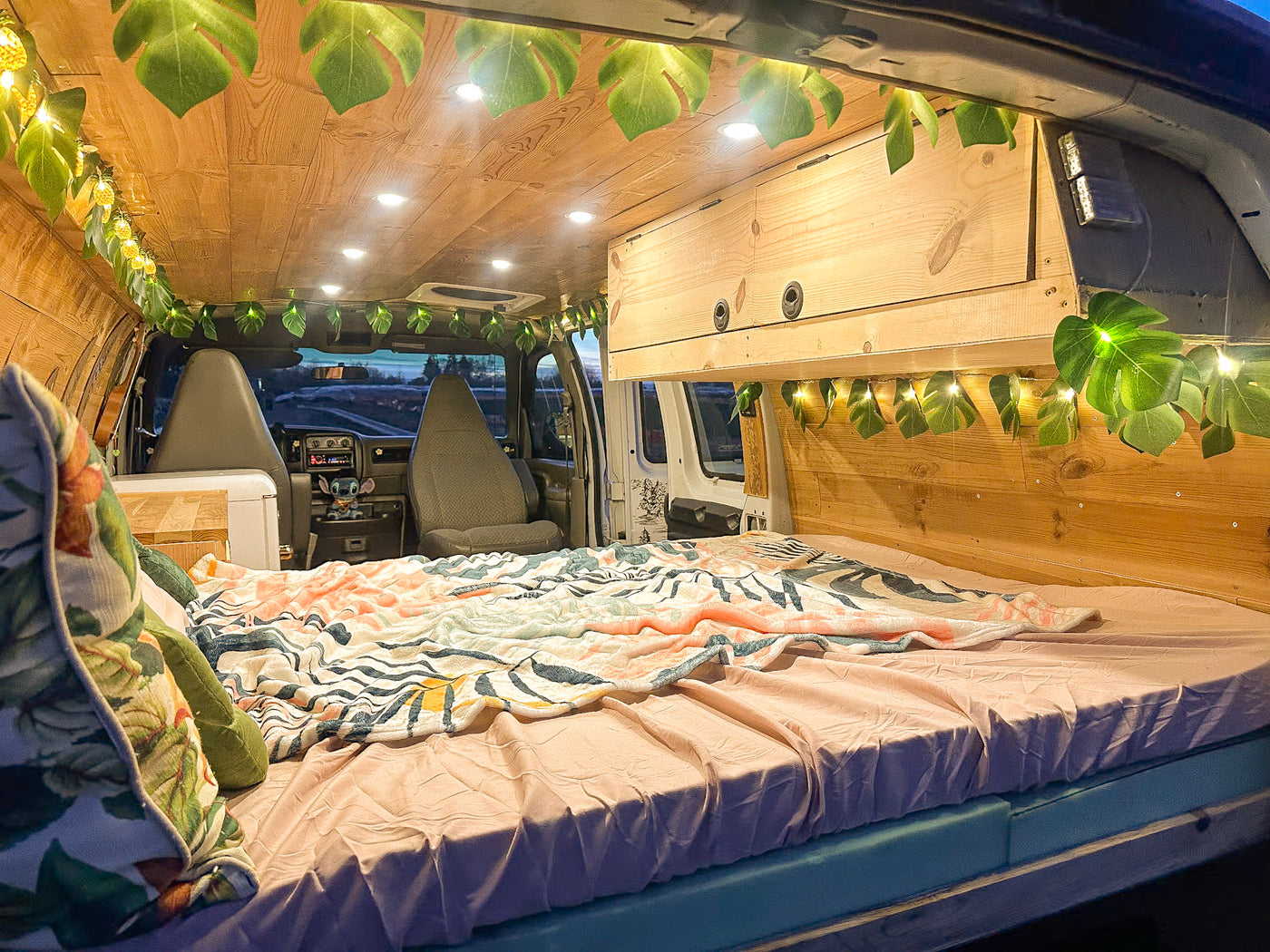  and a retro fridge.|This RV rental interior features a cozy bed — photo 8