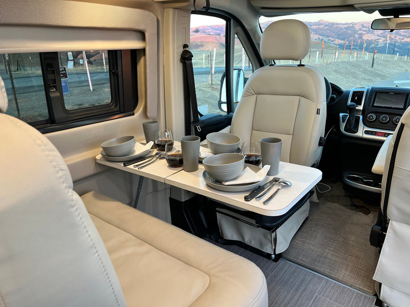  and panoramic sunset views.|Comfortable RV rental interior featuring light-colored seating — photo 10