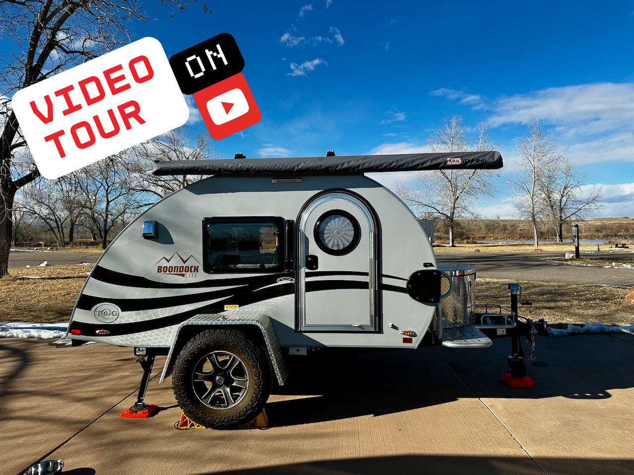 Video tour: This Boondock Lite teardrop, an ideal compact rv rental, is ready for camping adventures at a scenic lakeside park.