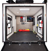 Spacious RV rental toy hauler interior. Features durable floor, side doors, storage, and AC. Perfect for hauling adventure gear.