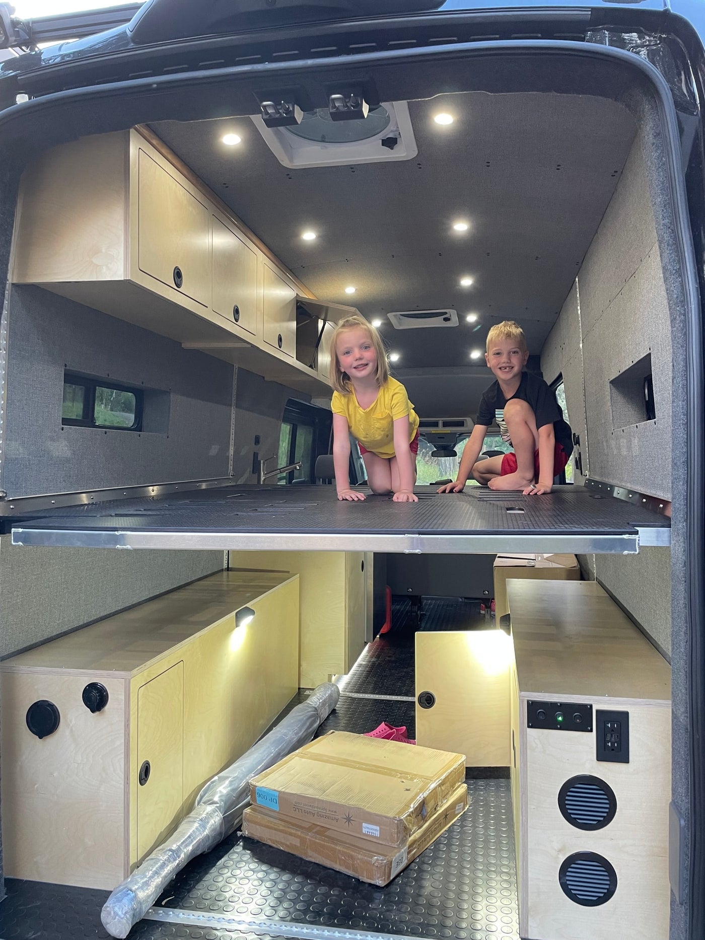  and a campfire illuminate this desert campsite below rocky cliffs.|RV rental camper van interior featuring a Nectar bed — photo 11