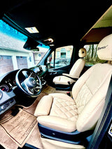 Experience the luxurious interior of this RV rental, featuring cream quilted leather seats and a modern Mercedes-Benz van cockpit.