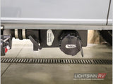 RV rental underside: Valterra gray waste tank drain, valve, and cap for waste disposal.