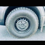 Close-up of a rugged Toyo Open Country A/T tire on a black Mercedes wheel, ideal for an RV rental vehicle.