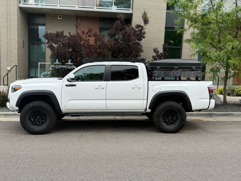 A white Toyota Tacoma TRD Pro pickup truck with a rooftop tent, an overlanding rig ready for adventure, like an RV rental. — photo 15