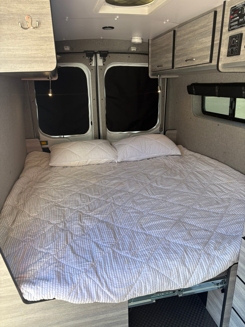 Cozy RV rental bed with built-in storage and blackout window covers, ready for your next adventure. — photo 8