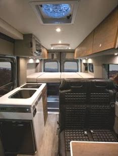  ready for overland adventures.|A Storyteller Overland Mercedes Sprinter rv rental camper van is parked in a sunny forest — photo 3