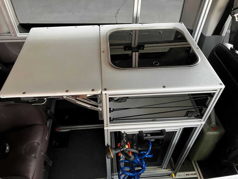 RV rental: Modular kitchen unit with a sink, extendable counter, integrated storage, and a portable water hose. — photo 15
