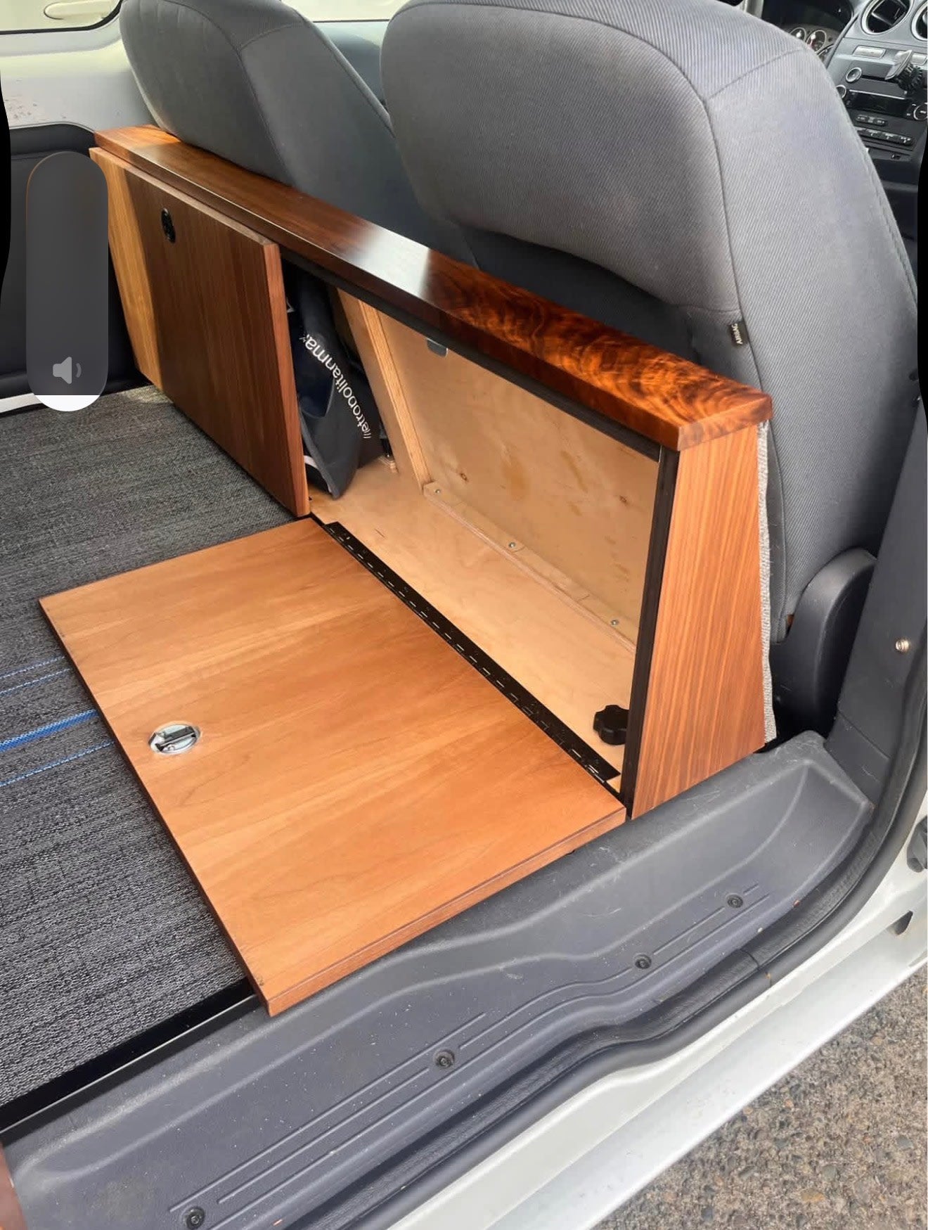  with the door open to the outdoors.|Cozy RV rental interior with grey cushioned bed — photo 8