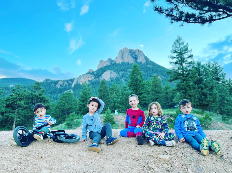 Five children posed on a dirt path with mountains & trees in the background. An RV rental trip would be perfect for this family outdoor fun! — photo 8