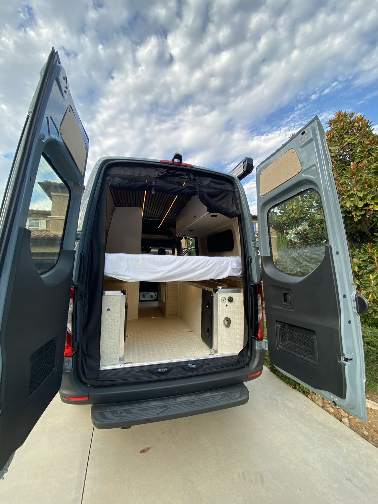  and versatile dining space.|Stylish RV rental interior: modern camper van with functional kitchen — photo 13